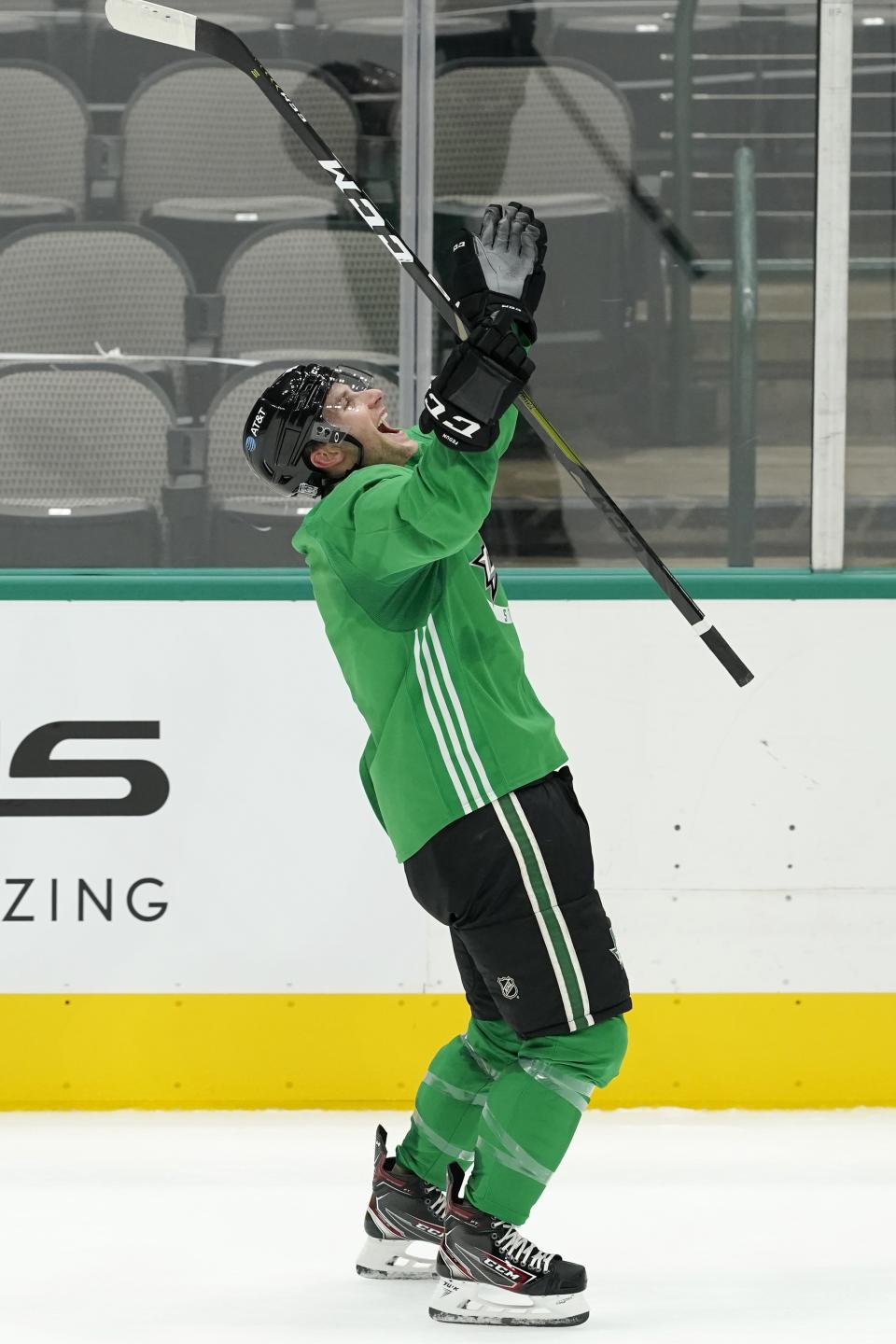 Dallas Stars' Taylor Fedun celebrates after scoring the winning goal on a shoot-out drill during NHL hockey practice in Dallas, Thursday, Jan. 21, 2021. (AP Photo/Tony Gutierrez)