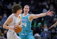 Charlotte Hornets center Mason Plumlee (24) defends against Oklahoma City Thunder guard Josh Giddey during the first half of an NBA basketball game Friday, Jan. 21, 2022, in Charlotte, N.C. (AP Photo/Rusty Jones)