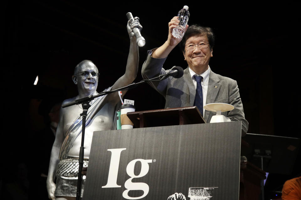 FILE - In this Sept. 12, 2019 file photo, Shigeru Watanabe, of Japan, receives the Ig Nobel award in chemistry for estimating the total saliva volume produced per day by a typical five-year-old, at the 29th annual Ig Nobel awards ceremony at Harvard University, in Cambridge, Mass. The spoof prizes for weird and sometimes head-scratching scientific achievement will be presented online in 2021 due to the coronavirus pandemic. (AP Photo/Elise Amendola, File)