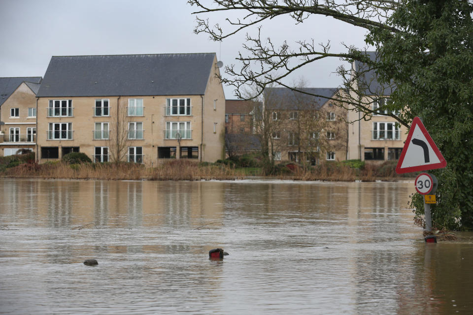 ST NEOTS, CAMBRIDGESHIRE, UNITED KINGDOM - 2024/01/06: A traffic sign stands redundant as flood water covers the road at St Neots as the River Great Ouse bursts its banks. Flood alerts remain in place as waters continue to rise in the east of England following storm Henk. Main rivers the River Great Ouse and the River Nene have burst their banks and spilled onto the surrounding countryside and with drains full to capacity they are backing up in residential areas. (Photo by Martin Pope/SOPA Images/LightRocket via Getty Images)