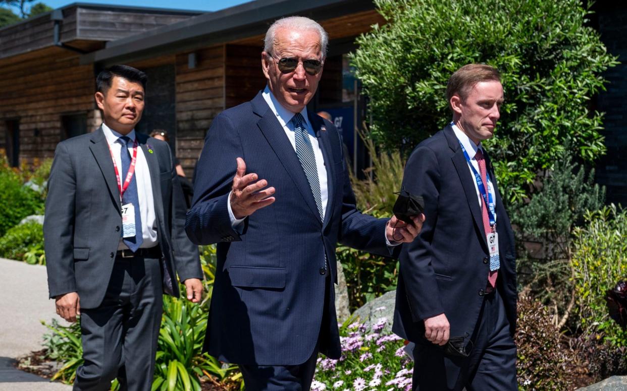 President Joe Biden walks with national security adviser Jake Sullivan, right, and members of the Secret Service  - Doug Mills/Pool The New York Times 