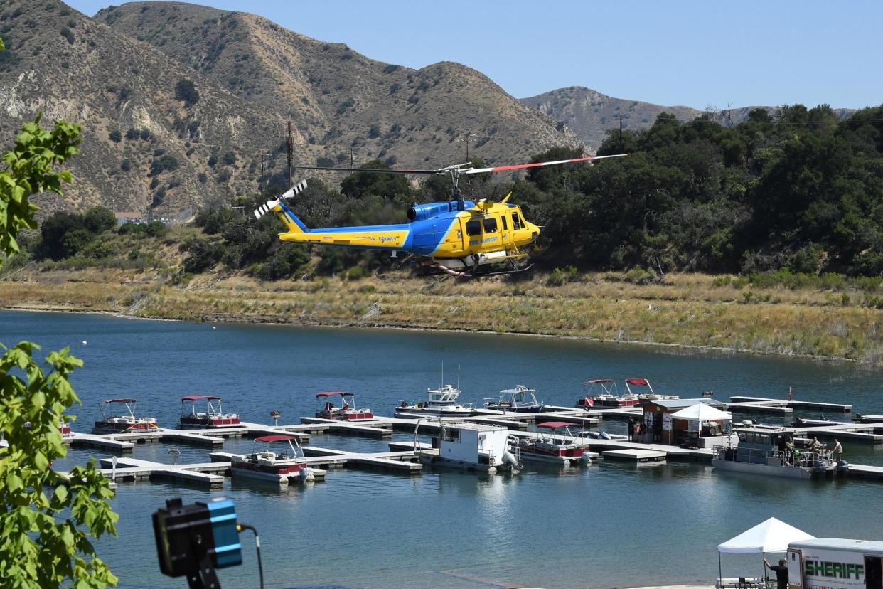 A Ventura County Sheriff's helicopter returns to base during the search to find Naya Rivera on 10 July 2020 at Lake Piru, California: ROBYN BECK/AFP via Getty Images