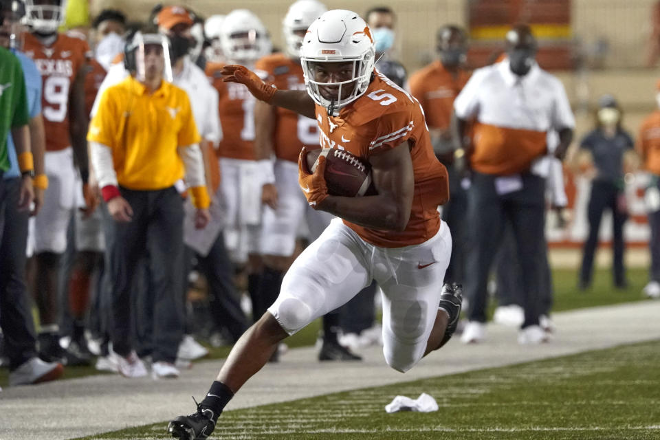 Texas' Bijan Robinson (5) runs for a long gain after a catch against UTEP during the first half of an NCAA college football game in Austin, Texas, Saturday, Sept. 12, 2020. (AP Photo/Chuck Burton)