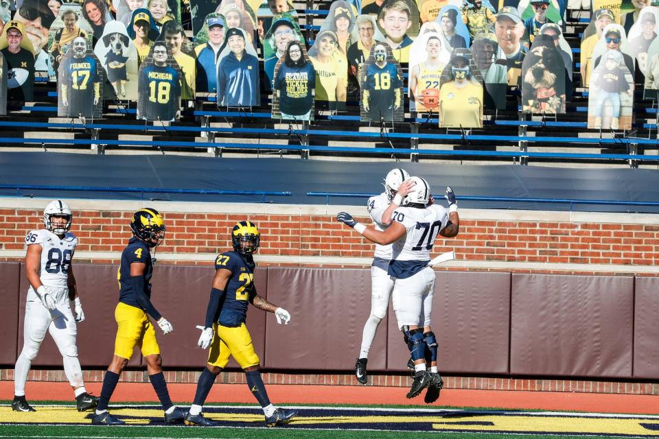 Penn State quarterback Sean Clifford, left, and offensive lineman Juice Scruggs celebrate a touchdown against Michigan  during the first half at Michigan Stadium in Ann Arbor, Saturday, Nov. 28, 2020.