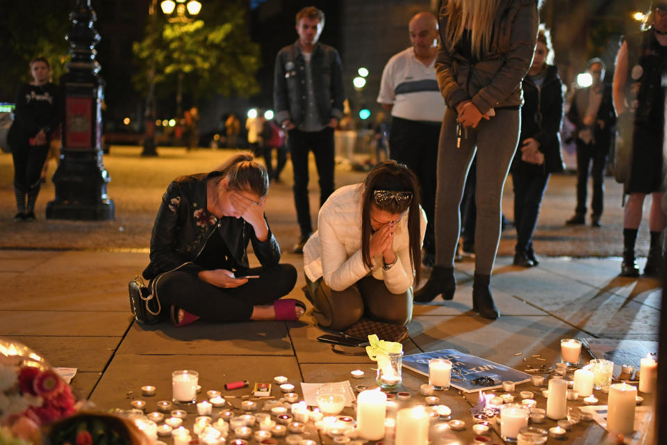 Members of the public attend a candlelit vigil, to honor the victims of Monday evening's terror attack, at Albert Square in Manchester.