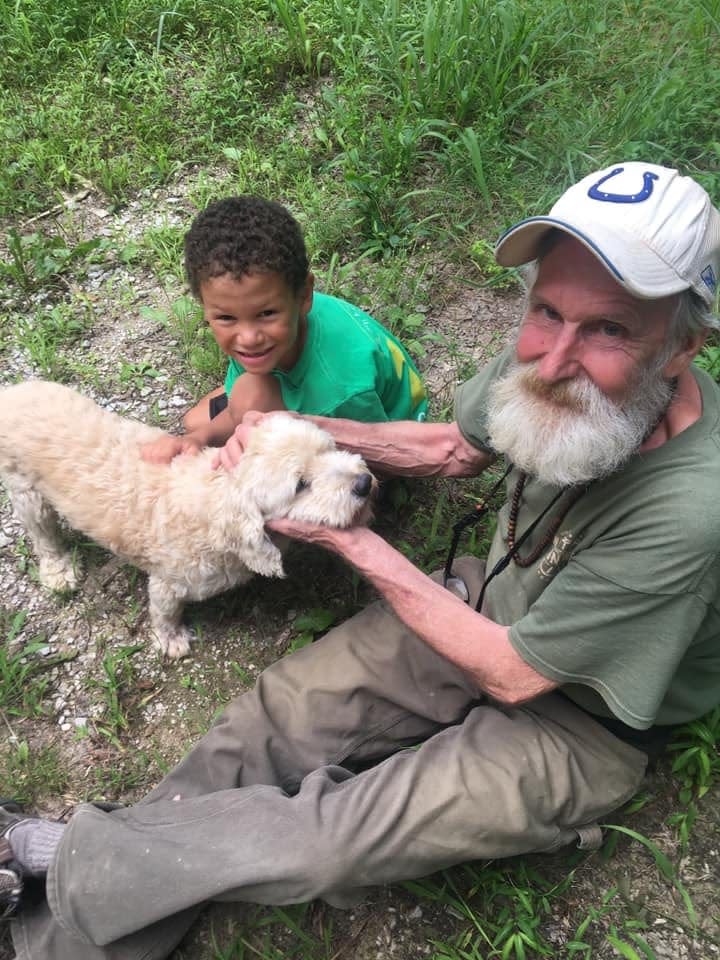 Bob Adair with his grandson, Tyrion James Horace, and Fuzzy, one of Adair's dogs.