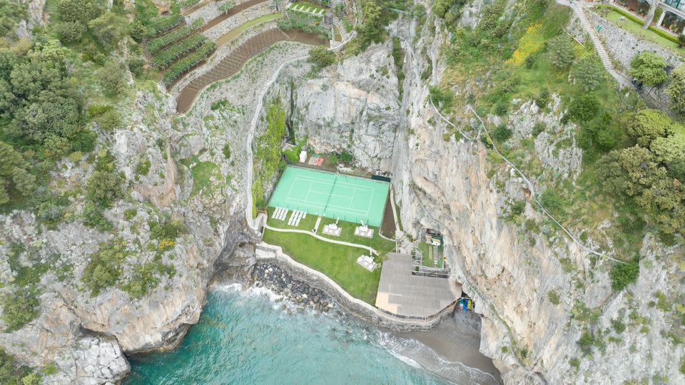 Reached by a few hundred steps, the tennis court at Hotel Il San Pietro Di Positano in Italy is between the cliff face and the pebble beach. - Nick Pachelli