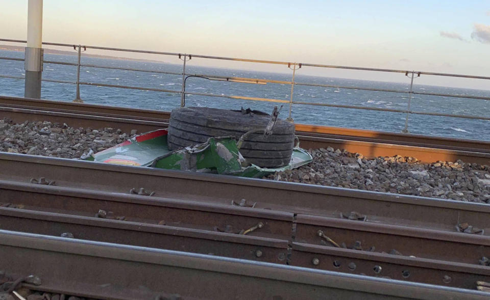 In this UGC photo made available by a source wishing to remain anonymous, a view of debris on the tracks after a train accident on the Great Belt Bridge, in Nyborg, Denmark, Wednesday, Jan. 2, 2019. At least six people were killed in a train accident early Wednesday on a Danish bridge linking the central islands of Zealand and Funen, according to the rail operator. Authorities said several others were injured. Police spokesman Lars Braemhoej said that while "we do not know precisely what caused the accident," one possible cause was that cargo from a passing freight train fell off and hit the passenger train. He added there was "considerable damage" on the passenger train. (Anonymous Source via AP)