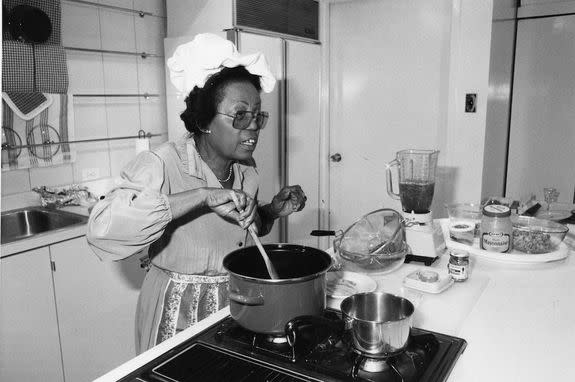 Mattie Smith Colin, who served as a reporter and the food and fashion editor of the Chicago Defender over a 50-year career, stirs a pot during a cooking demonstration in 1985.