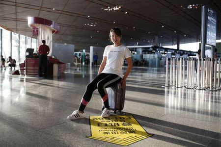 Zuo Aining poses for pictures at Beijing airport, China, before flying home to Washington, D.C. where she works as an Senior associate in credit risk advisory at KPMG, September 7, 2017. Picture taken September 7, 2017. REUTERS/Thomas Peter