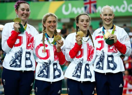 Aug 13, 2016; Rio de Janeiro, Brazil; Team Great Britain, Katie Archibald (GBR), Laura Trott (GBR), Elinor Barker (GBR) and Joanna Rowsell-Shand (GBR), celebrates winning the gold medal in the women's cycling track team pursuit event at Rio Olympic Velodrome during the Rio 2016 Summer Olympic Games. Mandatory Credit: Andrew P. Scott-USA TODAY Sports