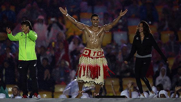 Look who’s back! Tongan flag bearer Pita Taufatofua jumps on stage during the Closing Ceremony. Pic: Getty