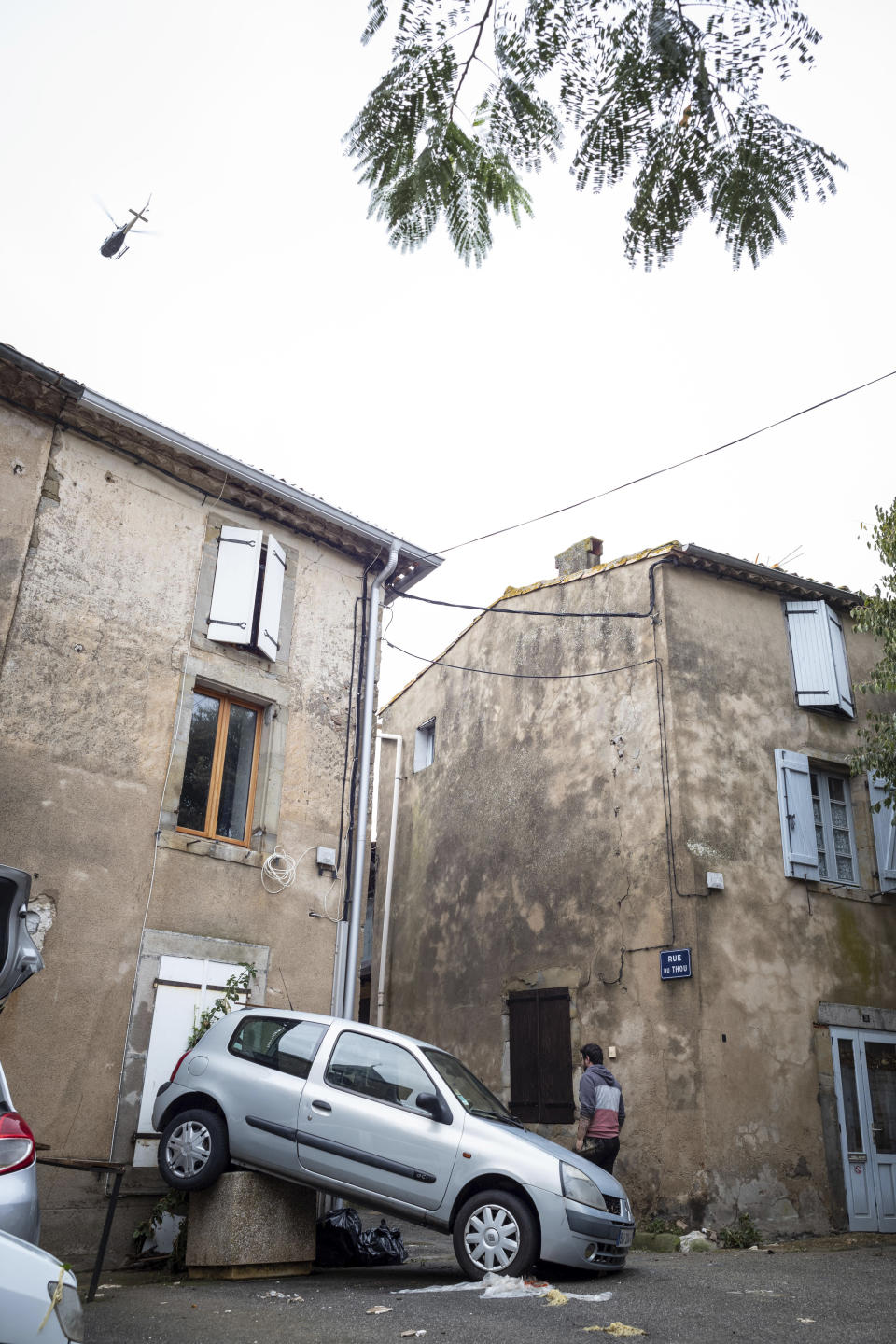 An helicopter flies over the town of Villegailhenc, southern France, after flash floods Monday, Oct.15, 2018. Flash floods tore through towns in southwest France, turning streams into raging torrents that authorities said killed several people and seriously injured at least five others. (AP Photo/Fred Lancelot)