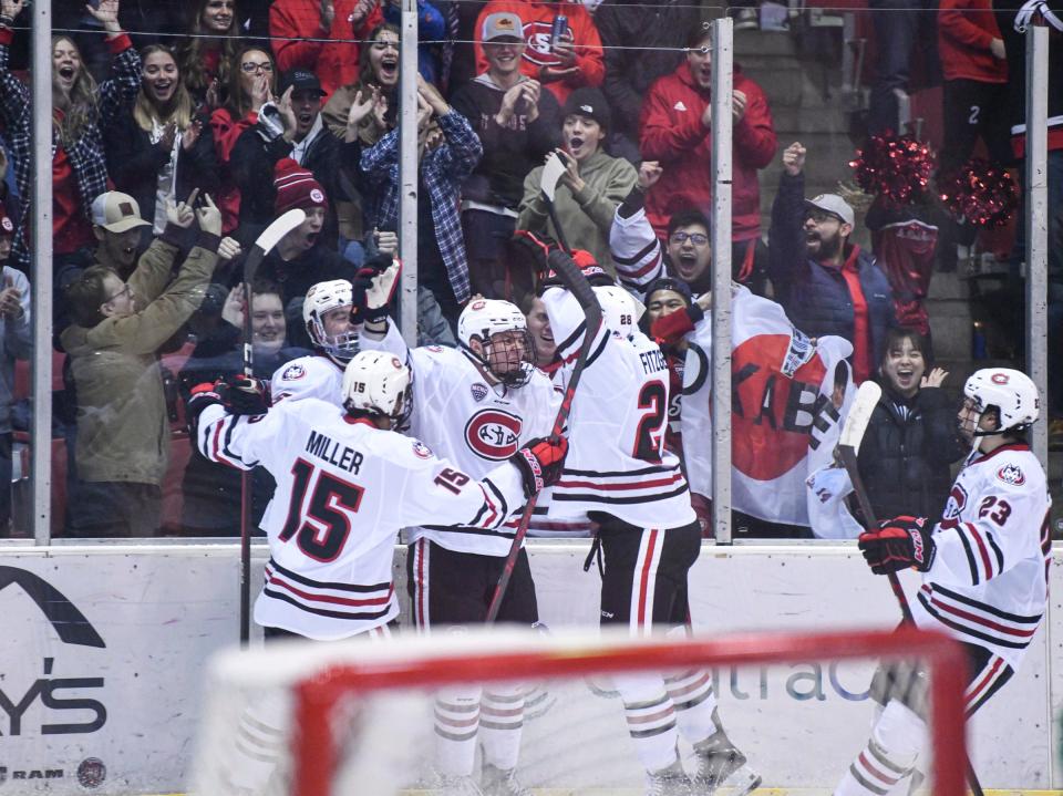 St. Cloud State players celebrate a goal by St. Cloud State's Kyler Kupka 18 seconds into the first period of the game Friday, Dec. 3, 2021, at the Herb Brooks National Hockey Center in St. Cloud.