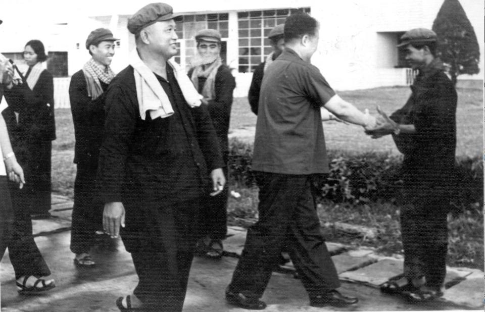 Nuon Chea, center, walks alongside fellow cadres. Chea was Deputy Secretary of the Communist Party of Kampuchea, a member of the Standing Committee and Central Committee of the Communist Party of Kampuchea, and Chairman of the Democratic Kampuchea People’s Assembly.