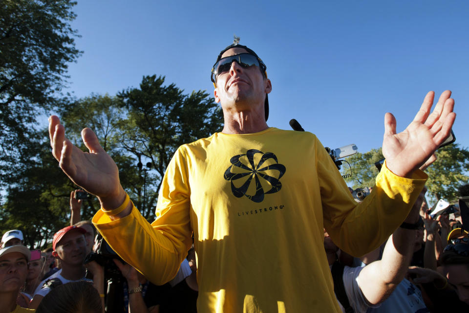 Lance Armstrong talks to supporters prior to a run, Wednesday, Aug. 29, 2012, on Mont Royal Park in Montreal. 