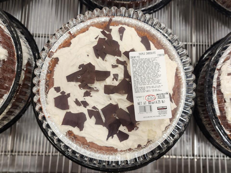 Bird's-eye-view of a pie with a brown crust, a white filling, a chocolate shavings