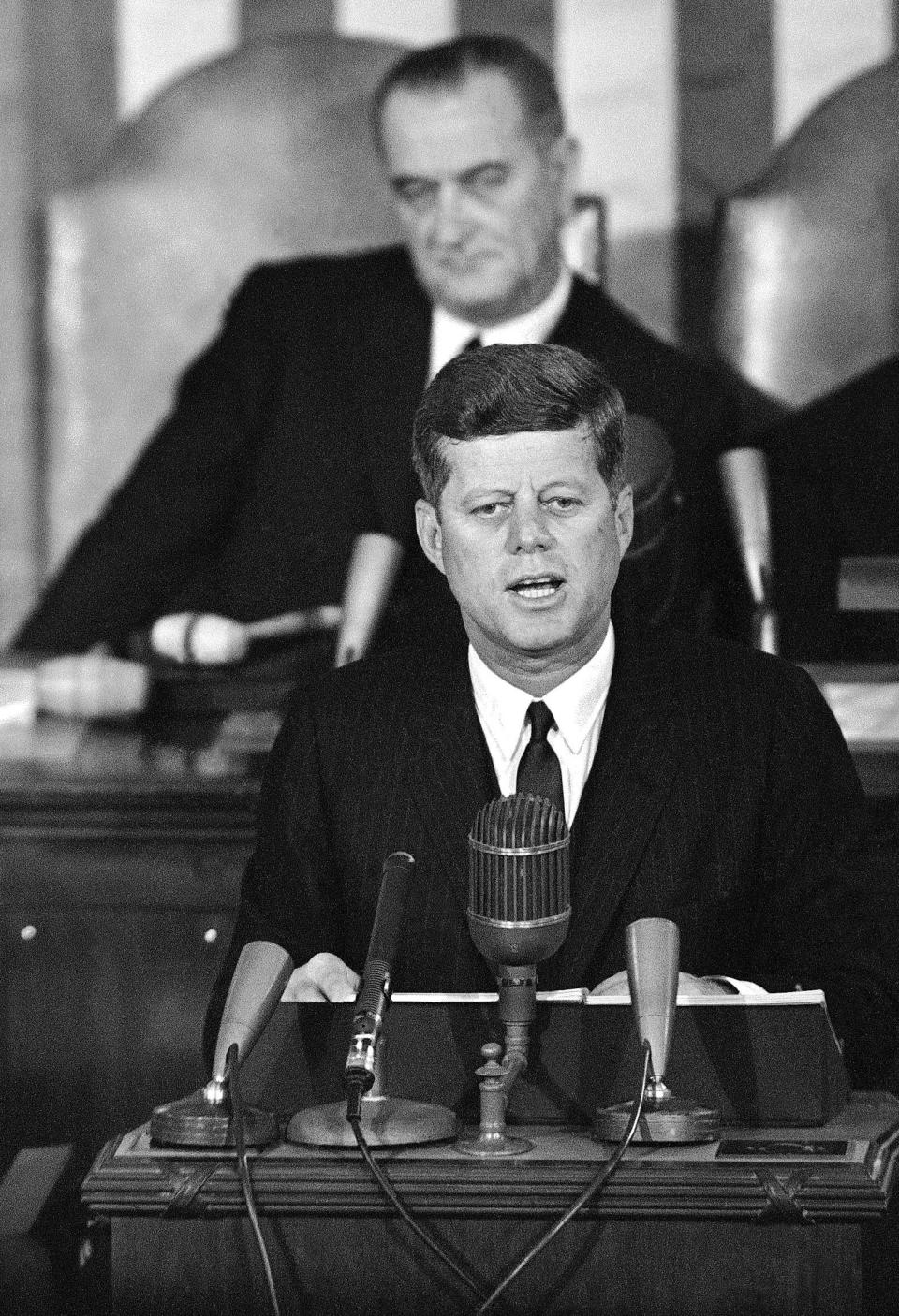 In this Jan. 14, 1963 file photo, President John F. Kennedy speaks in the House Chamber on Capitol Hill in Washington during his State of the Union report to a joint session of Congress with Vice President Lyndon Johnson sitting behind him. (AP Photo/File)