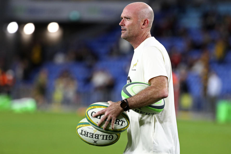 South Africa's head coach Jacques Nienaber collects balls as his team warms up ahead of their Rugby Championship match against Australia on Sunday, Sept. 12, 2021, Gold Coast, Australia. (AP Photo/Tertius Pickard)