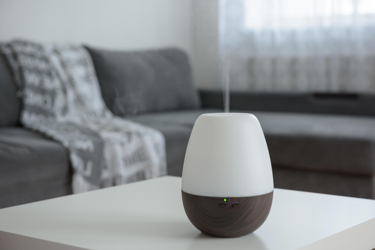 Essential Oil Diffusers on a white table on the background of the interior.