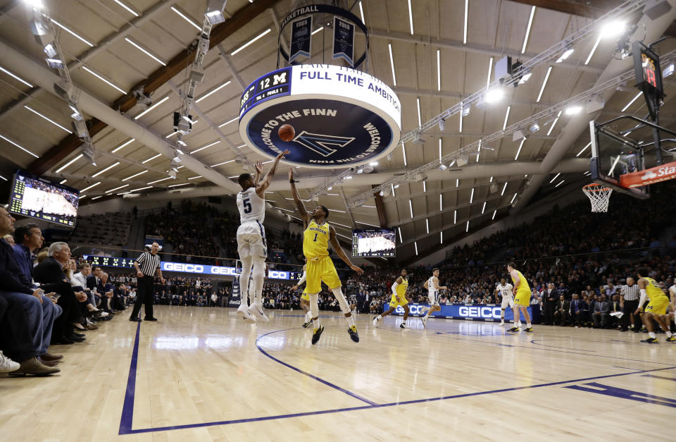 Villanova's Phil Booth (5) goes up for a shot against Michigan's Charles Matthews (1) during the first half of an NCAA college basketball game, Wednesday, Nov. 14, 2018, in Villanova. (AP Photo/Matt Slocum)