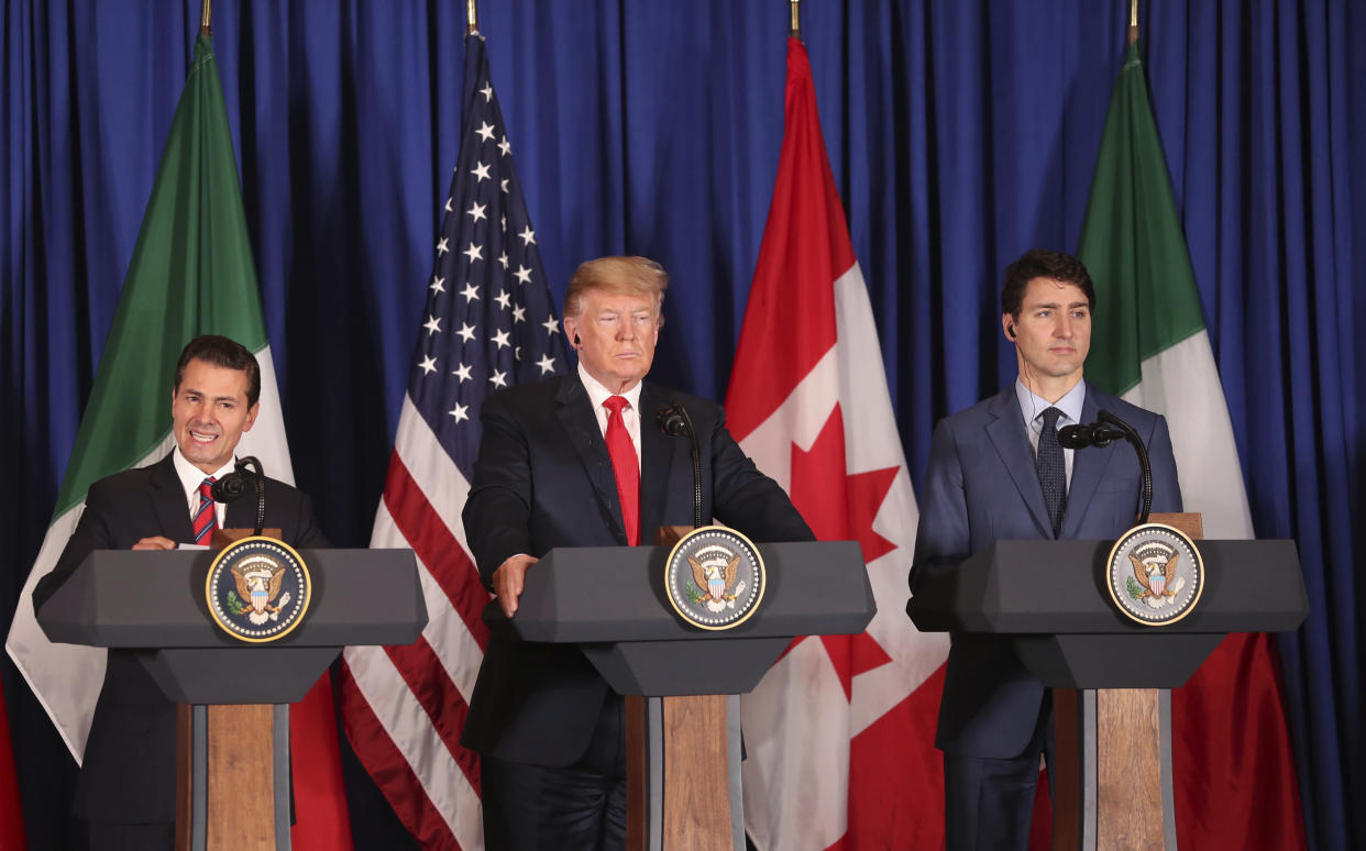 President Donald Trump, center, Canada's Prime Minister Justin Trudeau, right, and Mexico's President Enrique Pena Nieto hold a joint news conference before signing a new United States-Mexico-Canada Agreement that is replacing the NAFTA trade deal, during a ceremony at a hotel before the start of the G20 summit in Buenos Aires, Argentina, Friday, Nov. 30, 2018. The USMCA, as Trump refers to it, must still be approved by lawmakers in all three countries. (AP Photo/Martin Mejia)