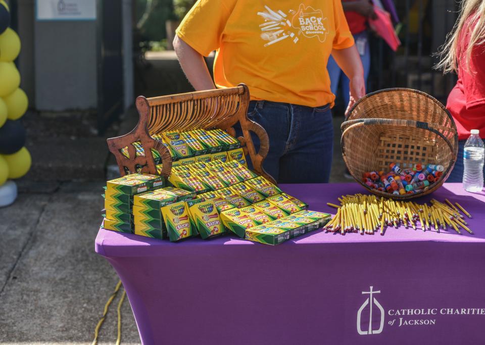 Crayons, pencils, and glue sticks are some of the many items up for grabs at the Catholic Charities, Inc. school supply giveaway in Jackson on Friday. The giveaway provides access to school supplies for locals in the community.