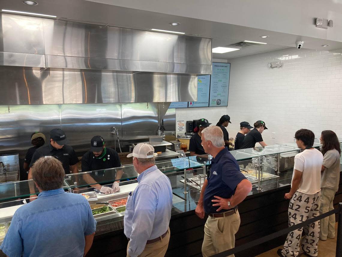 Guests in serving line for made-to-order Tex-Mex food at the new Surcheros Fresh Mex restaurant in Warner Robins at a friends and family event prior to opening.