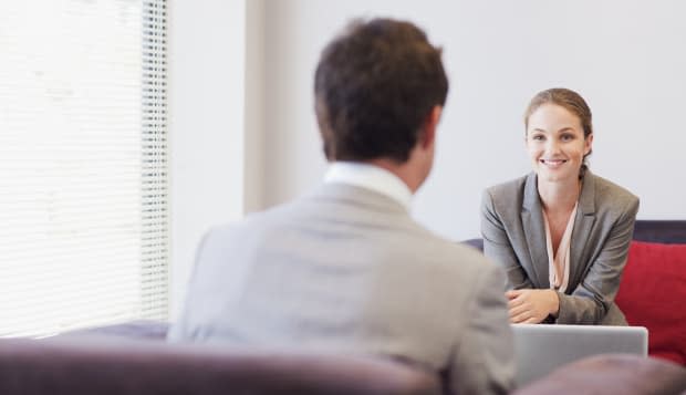 Business people talking face to face in lobby