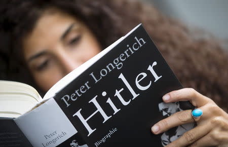 A woman reads Peter Longerich's new book "Hitler" in Berlin, Germany, November 5, 2015. REUTERS/Hannibal Hanschke