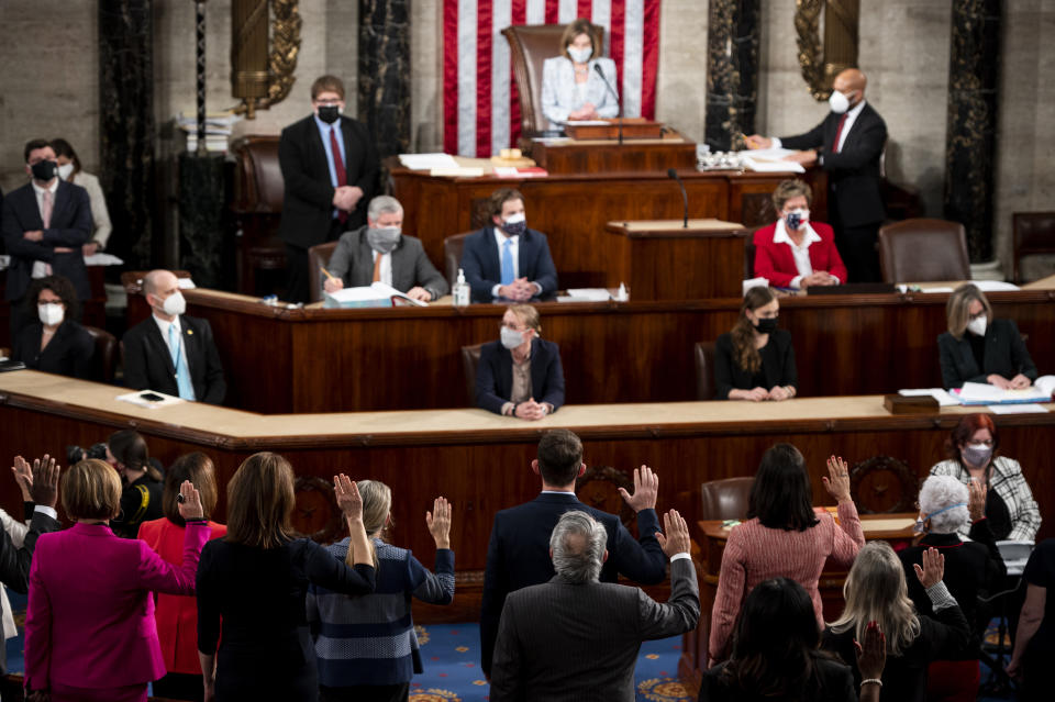 FILE - In this Jan. 3, 2021, file photo, House Speaker Nancy Pelosi administers the oath of office to members of the 117th Congress at the U.S. Capitol in Washington. The oath, which normally doesn’t attract much attention, has become a common subject in the final days of the Trump presidency, being invoked by members of both parties as they met Wednesday, Jan. 6, 2021 to affirm Biden's win and a pro-Trump mob stormed the U.S. Capitol. (Bill Clark/Pool Photo via AP, File)