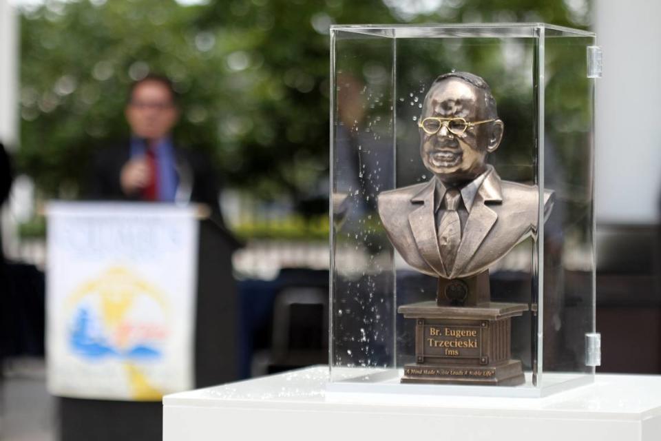 A statue of Brother Eugene Trzecieski is unveiled during a dedication ceremony at Christopher Columbus High School honoring Brother Eugene who has taught at the school, mainly on the subject of philosophy, for 43 years, on Tuesday, March 29, 2011.