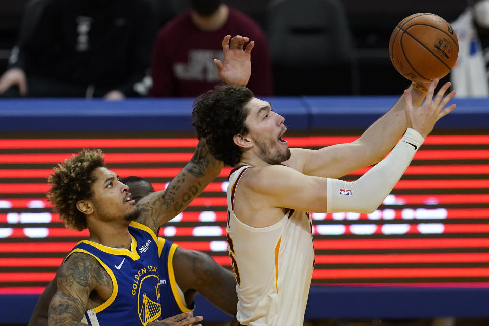 Cleveland Cavaliers forward Cedi Osman, right, shoots in front of Golden State Warriors guard Kelly Oubre Jr. during the second half of an NBA basketball game in San Francisco, Monday, Feb. 15, 2021. (AP Photo/Jeff Chiu)