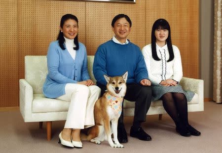 Japan's Crown Prince Naruhito (C) smiles as he poses for a photograph with his wife Crown Princess Masako (L), daughter Princess Aiko (R) and their pet dog Yuri at his residence Togu Palace in Tokyo February 11, 2015, in this handout photo by the Imperial Household Agency of Japan received by Reuters February 23, 2015. REUTERS/Imperial Household Agency of Japan/Handout via Reuters