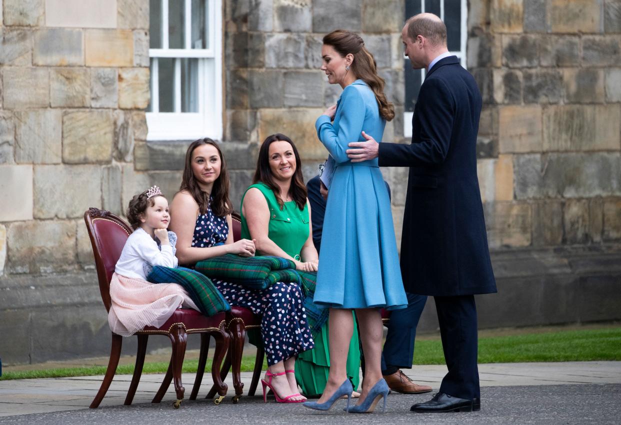 Five year-old cancer patient Mila Sneddon (L), who features in an image from the Hold Still photography project, speaks to Britain's Prince William, Duke of Cambridge and Britain's Catherine, Duchess of Cambridge as she and her family attend a Beating Retreat by The Massed Pipes and Drums of the Combined Cadet Force in Scotland as special guests of the Royal couple, at the Palace of Holyroodhouse in Edinburgh, Scotland on May 27, 2021, the final day of their week-long visit to the country. (Photo by Jane Barlow / POOL / AFP) (Photo by JANE BARLOW/POOL/AFP via Getty Images)