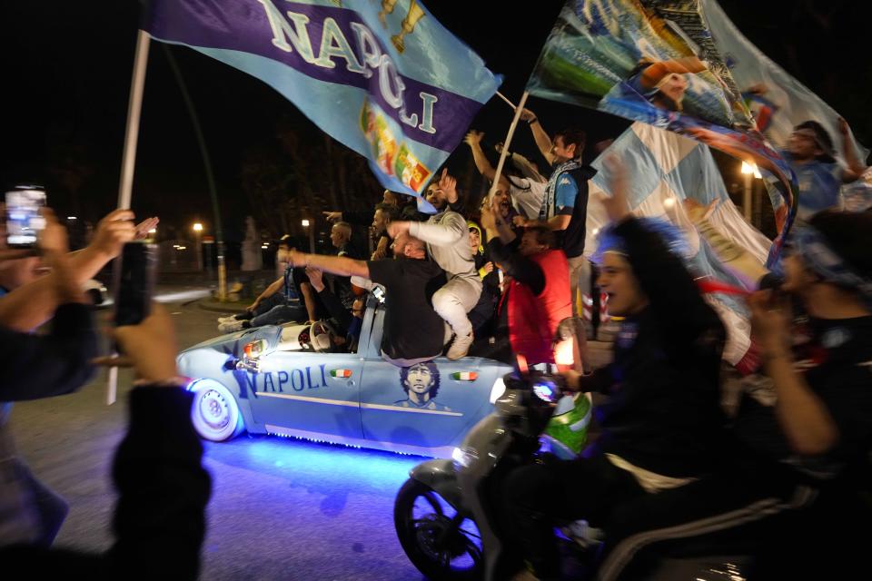 Napoli fans celebrate after winning the Italian league soccer title, in Naples, Italy, Thursday, May 4, 2023. Napoli won its first Italian soccer league title since the days when Diego Maradona played for the club, sealing the trophy with a 1-1 draw at Udinese on Thursday. (AP Photo/Andrew Medichini)