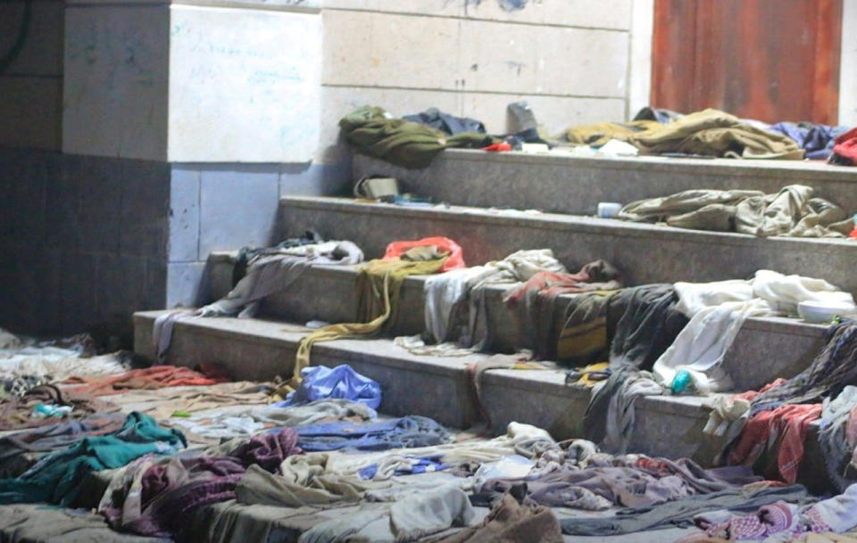 Clothes strewn about on a stairway.