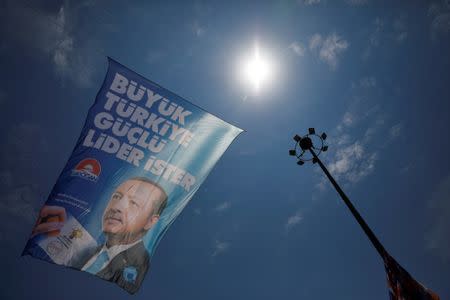 An election poster of Turkish President Tayyip Erdogan is pictured at a rally in Istanbul, Turkey June 22, 2018. REUTERS/Alkis Konstantinidis