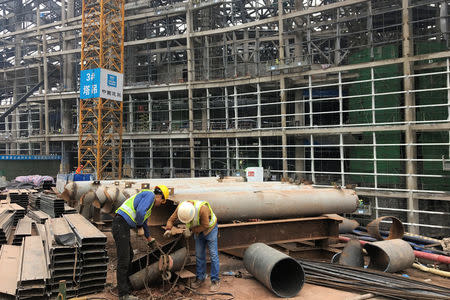 Workers are seen at a construction site of an online gaming stadium in Zhongxian, Chongqing, China November 13, 2017. REUTERS/ Yawen Chen