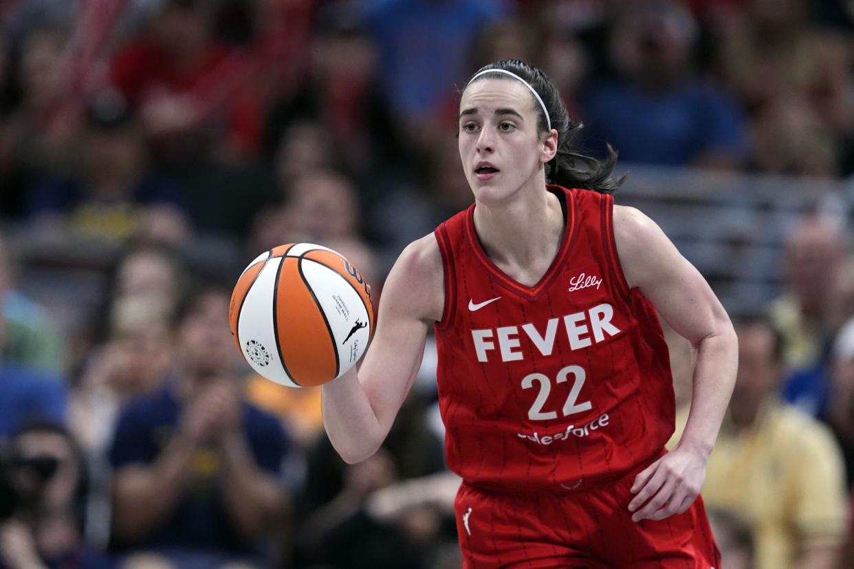 Indiana Fever's Caitlin Clark dribbles during the second half of a WNBA basketball game against the New York Liberty, Saturday, July 6, 2024, in Indianapolis. (AP Photo/Darron Cummings)