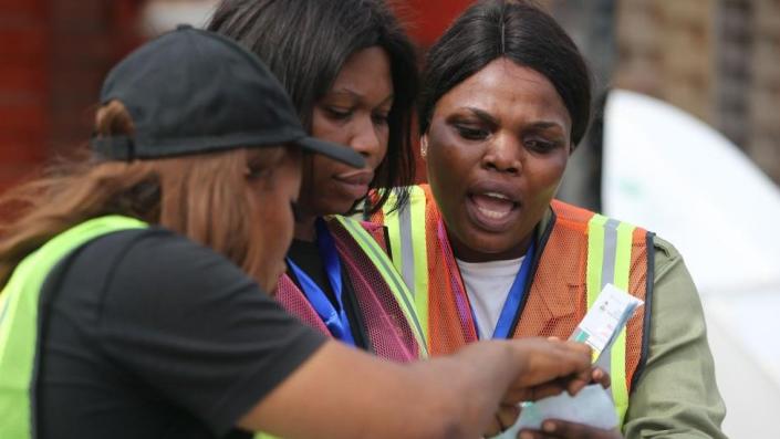 Electoral officers check a voting slip after the vote count at a polling station during the general elections, in the Ikeja district of Lagos