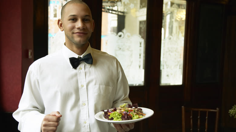 Waiter holding a plate