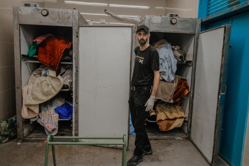 A Palestinian hospital worker stands next to the bodies of Palestinian men in the mortuary of Tulkarm Hospital, after Israel's military said 14 terrorists were killed in an operation at the Nur Shams refugee camp, in Tulkarm, in the Israeli-occupied West Bank, April 21, 2024. / Credit: WAHAJ BANI MOUFLEH/Middle East Images/AFP via Getty Images