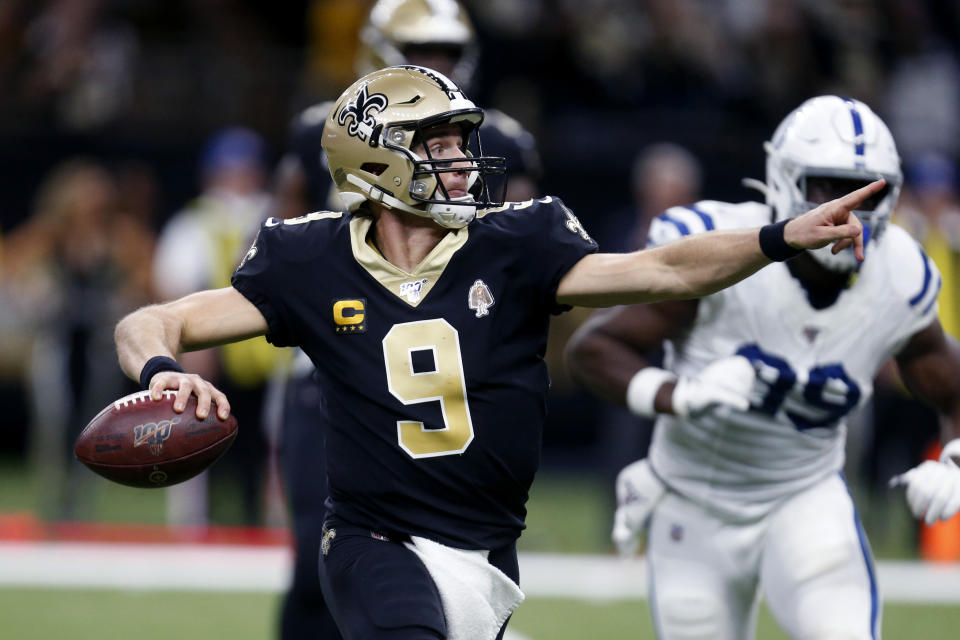 CORRECTS SECOND SENTENCE REFERENCE TO COMPLETIONS TO 27TH PASS OF THE GAME ON 28 ATTEMPTS New Orleans Saints quarterback Drew Brees (9) scrambles to pass in the first half of an NFL football game against the Indianapolis Colts in New Orleans, Monday, Dec. 16, 2019. The completion was also Brees' 27th of the game on 28 passing attempts. (AP Photo/Butch Dill)