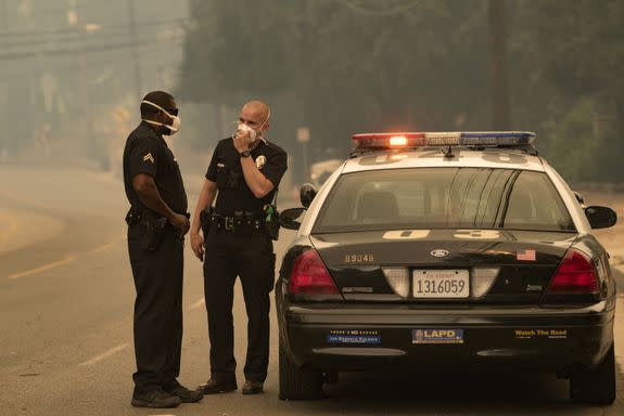 Police officers wearing masks due to the heavy smoke caused by the La Tuna Fire on September 2, 2017.