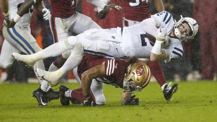 Indianapolis Colts quarterback Carson Wentz, top, falls forward as he is tackled by San Francisco 49ers safety Talanoa Hufanga during the second half of an NFL football game in Santa Clara, Calif., Sunday, Oct. 24, 2021. (AP Photo/Tony Avelar)