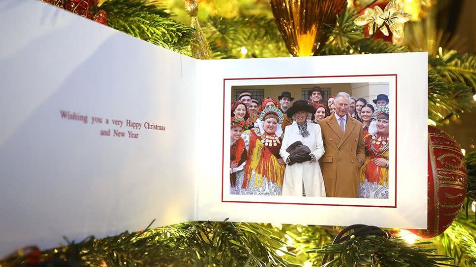 Charles and Camilla share a snap with Croatian dancers on this year's Christmas card. Photo: AAP