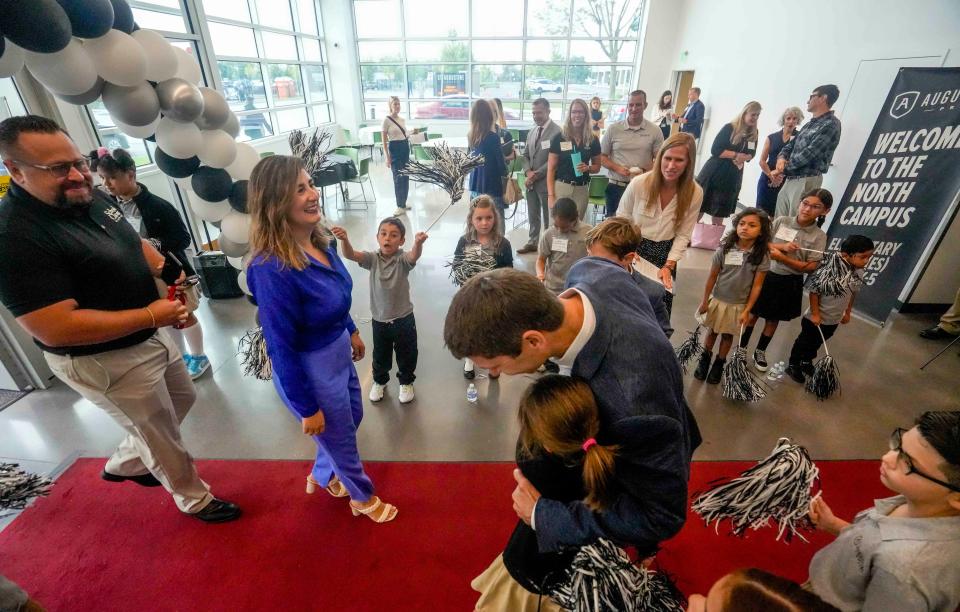 St. Augustine Preparatory Academy students welcome guests during the grand opening of the new $49 million elementary school Tuesday.