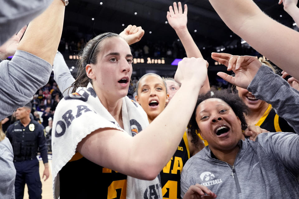 Iowa guard Caitlin Clark, left, celebrates with teammates after Iowa defeated Northwestern 110-74 in an NCAA college basketball game in Evanston, Ill., Wednesday, Jan. 31, 2024. (AP Photo/Nam Y. Huh)