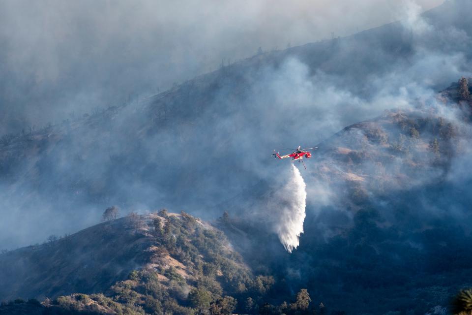 A helicopter drops water on the Sheep Fire in Wrightwood, California, on June 12, 2022.